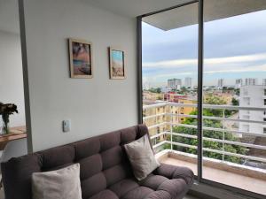 a living room with a couch and a large window at Relax apartamento in Cartagena de Indias