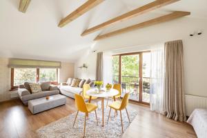 a living room with a couch and a table and chairs at Vila Epušė in Palanga