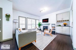 ein Wohnzimmer mit Couch und Kamin in der Unterkunft Bright Luxury Home-Hot Tub-Sunroom-King Bed-AC in Edmonton