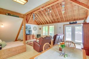 a living room with a table and chairs at Tennessee Cabin Getaway Near Dale Hollow Lake! in Frogue