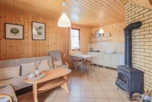 a living room with a couch and a stove at Mandala Domki in Bobolin +39 photos