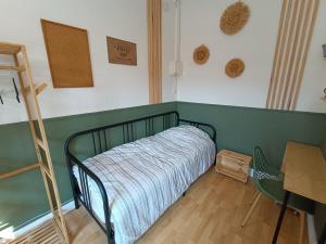 a bedroom with a bed and a ladder and a desk at Les Madeleines de Saint-Omer in Saint-Omer