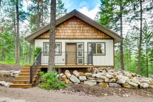 a tiny house in the woods with a pile of rocks at Dreamy Montana Cabin Short Drive to Flathead Lake in Polson
