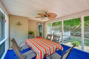 a screened in porch with a table and chairs at Porch and Fire Pit Shawnee on Delaware Home! in East Stroudsburg