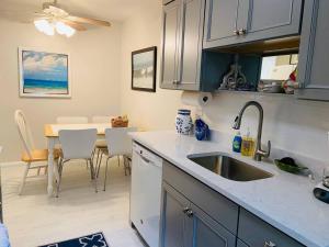 a kitchen with a sink and a table with chairs at Endless Beach #A,Oceanfront,3bedrooms-2bath-Pet Friendly in Virginia Beach