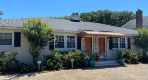 a white house with a red awning at Endless Beach #A,Oceanfront,3bedrooms-2bath-Pet Friendly in Virginia Beach