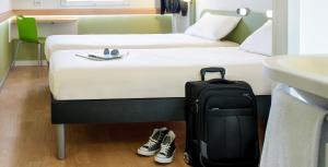 Postel nebo postele na pokoji v ubytování ibis budget Karlsruhe