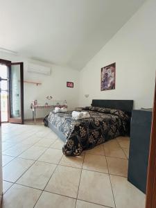 a bedroom with two beds and a tile floor at Villa Teresa in Ginosa Marina