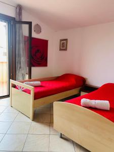 a bedroom with two beds with red sheets at Villa Teresa in Ginosa Marina +29 photos