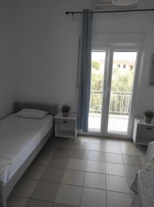 Postel nebo postele na pokoji v ubytování Noula Rooms