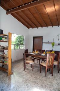 a dining room with a wooden table and chairs at CASA DE LOLA in Medellín