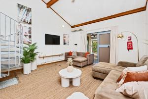 a living room with a couch and a table at 11 Cottesloe - steps from beach - sleeps 3 in Perth