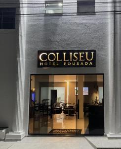 a building with a sign that reads coleshvelt hotel pushka at Hotel Pousada Colliseu in Aparecida