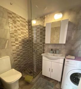 a bathroom with a toilet and a sink and a shower at Palaiopolis house in Kanoni