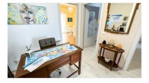 a room with a table and a mirror at Casa vacanze Turicò in Patti