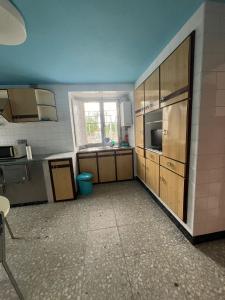 an empty kitchen with a sink and a window at Casa de campo adosada in Viveiro