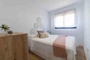 a white bedroom with a bed and a window at Artes Homes in San José +27 photos