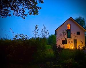 a white house with a window on the side of it at Estrella dreams in Amblève