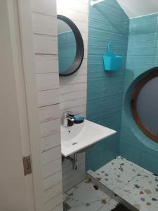 une salle de bain avec un lavabo et un miroir dans l'établissement Apartament Casa George Mamaia Nord, à Mamaia Nord – Năvodari