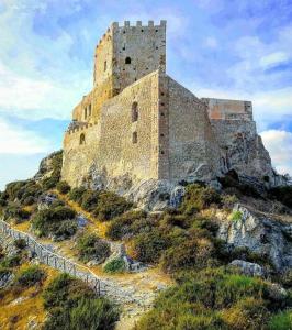 a castle on top of a rocky hill at 2 Apartment D3 Home in Palma di Montechiaro