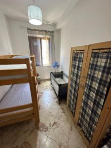 a room with a bunk bed and a couch at 2 Apartment D3 Home in Palma di Montechiaro +3 photos