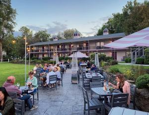 a group of people sitting at tables at a restaurant at Plum Point Lodge in Himrod