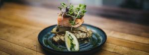 a blue plate with a sandwich on a table at Plum Point Lodge in Himrod