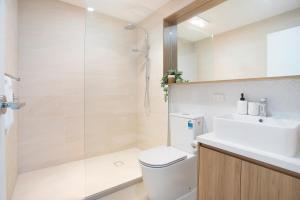 a bathroom with a shower and a toilet and a sink at Stud Park Residence by Ready Set Stay in Rowville