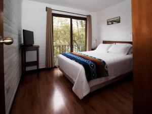 Postel nebo postele na pokoji v ubytování Apartamentos Otorongo Cuenca Ecuador