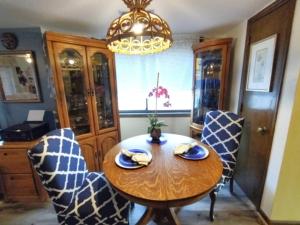 a dining room with a wooden table and chairs at Dragonfly Daze villa in Carolina Beach