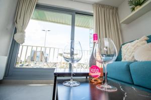 three wine glasses sitting on a table in a living room at Zeebries Studio in Ostend +12 photos