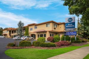 a best western sign in front of a hotel at Best Western Holiday Hotel in Coos Bay