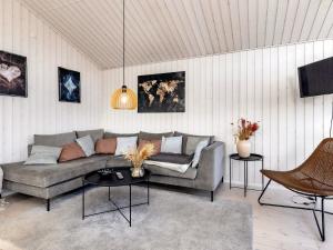 een woonkamer met een bank en een tafel bij 4 star holiday home in Væggerløse-By Traum in Bøtø By