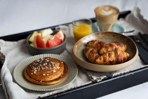 a tray of food with pastries and fruit on it at Radisson Blu 1919 Hotel, Reykjavík in Reykjavík +81 photos