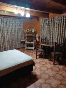 a bedroom with a bed and a table and chairs at Depa amoblado Samana Cruz in Cajamarca
