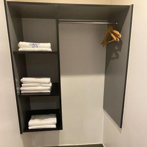 a closet with white towels on a shelf at Hotel Atenas Plaza in Mexico City