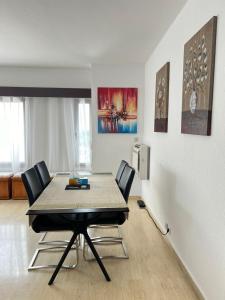 a dining room with a table and four chairs at Residence Roume Abidjan Plateau in Abidjan