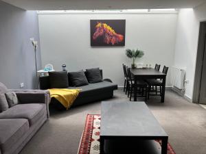 a living room with a couch and a table at Lancing Apartments - Spacious 2 Bed - Sleeps 6 - Burnham Village in Slough