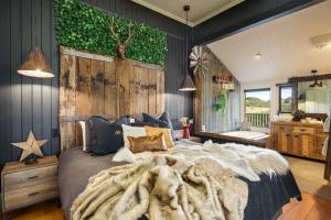 a bedroom with a large bed with a large blanket at Beam Creek Cottage - Montville in Montville