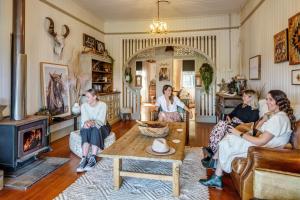 a group of women sitting in a living room at Beam Creek Cottage - Montville in Montville