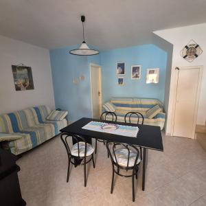 a living room with a table and chairs and a couch at Villa Sabaudia in Sabaudia