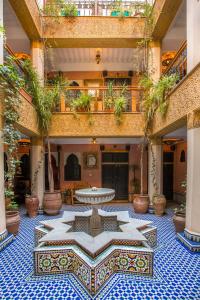 a courtyard with a table in the middle of a building at Riad Jnane Mogador in Marrakesh