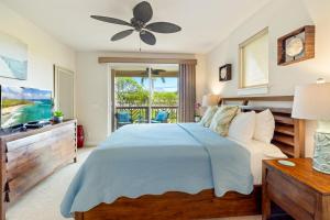 a bedroom with a bed and a television at Pili Mai 15H - Central A/C in Kipu +32 photos
