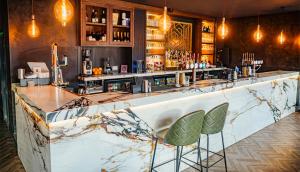 a bar with two chairs sitting at a counter at House of Suede by UNIS Estates in Sheffield