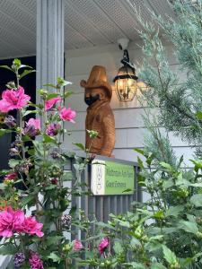 a statue of a bear on a porch with flowers at Mountain Ash Country Manor and Spa in Creemore