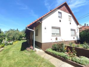 a white house with a garden in front of it at Holiday home in Agard - Velence-See 51093 in Agárd