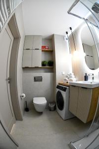 a small bathroom with a toilet and a sink at Elegant Two-Room Apartment, Sleeps 4, Near Turon Arena, Balcony ,Air condition in Kraków