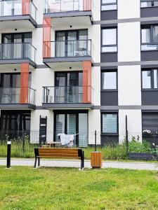 a park bench in front of a building at Elegant Two-Room Apartment, Sleeps 4, Near Turon Arena, Balcony ,Air condition in Kraków