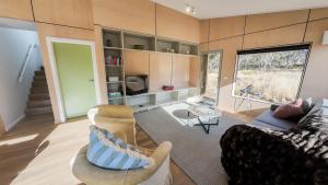 a living room with a couch and a tv at Fimian in Dinner Plain