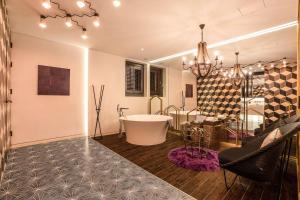 a bathroom with a tub and a table and a chair at Hotel The Designers Cheongnyangni in Seoul